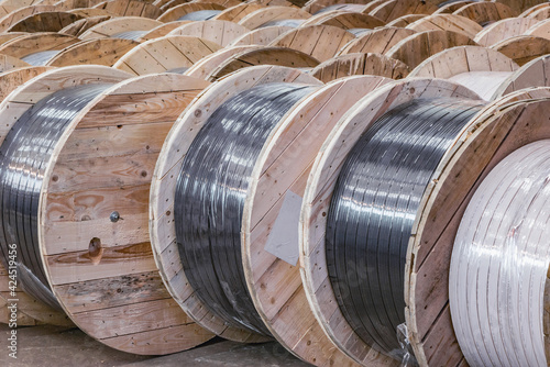 Large wooden spools with cable inside of the plant.