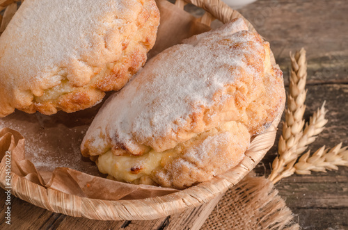 Delicious fresh culinary baked goods- sweet shortbreads with filling close-up on wooden