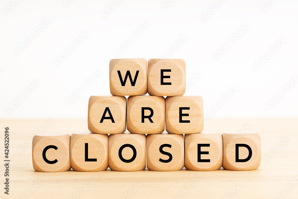 We are closed concept. Words on wooden blocks on table. Copy space We are closed concept. Words on wooden blocks on table. Copy space
