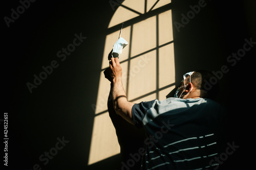 desperate person with mask at home due to the closure of the pandemic in times of covid. quarantine