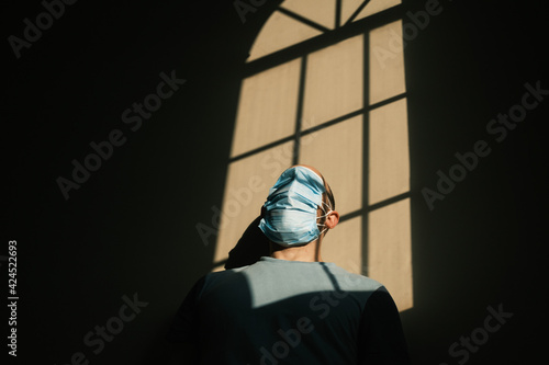 desperate person with mask at home due to the closure of the pandemic in times of covid. quarantine