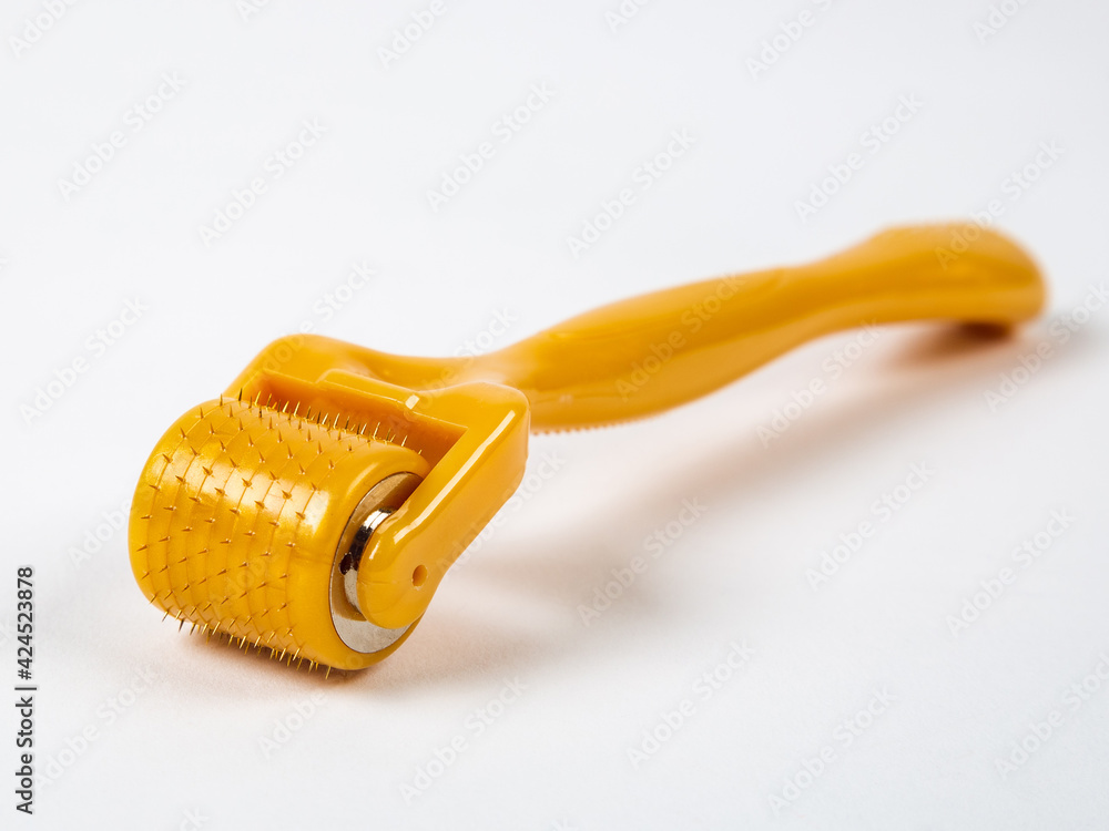 Mesoroller for the face on a white background. A tool for skin rejuvenation. Mesoroller for the face on a white background. A tool for skin rejuvenation.