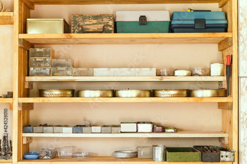 фотографія Wooden shelving units with different furniture in custom workroom