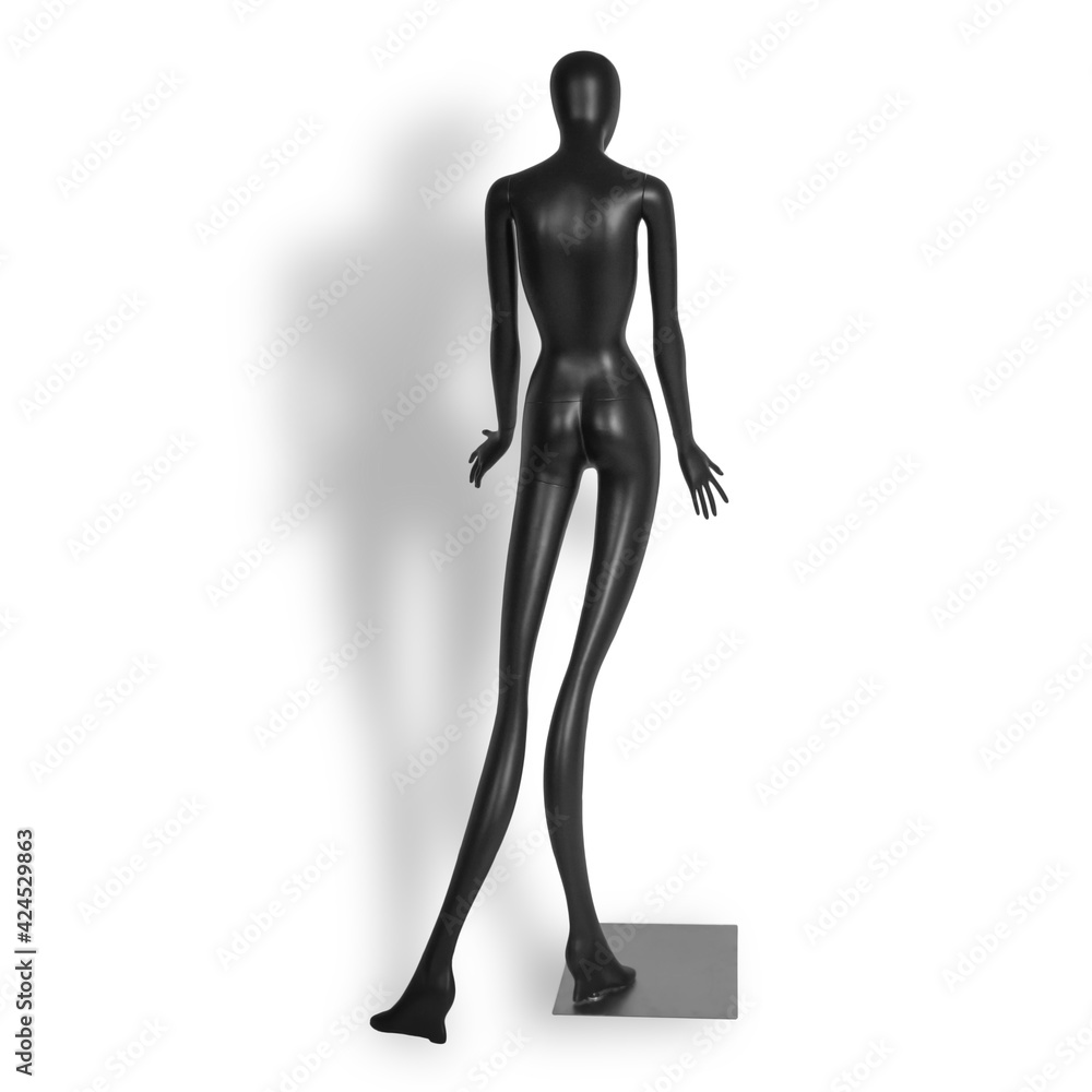 Modern plastic black mannequin with elongated limbs for designers isolated on white background. Back view Modern plastic black mannequin with elongated limbs for designers isolated on white background. Back view