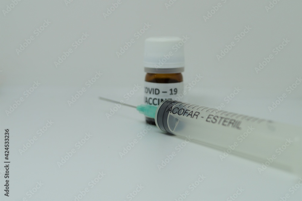 a vaccine for the covid pandemic and a syringe a vaccine for the covid pandemic and a syringe