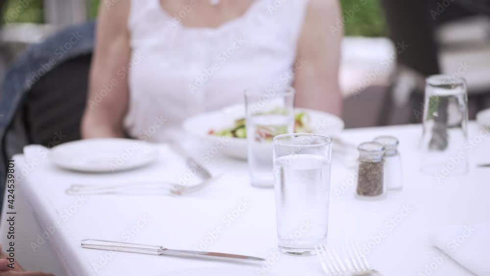 Waiter serving meal on the table at restaurant Waiter serving meal on the table at restaurant