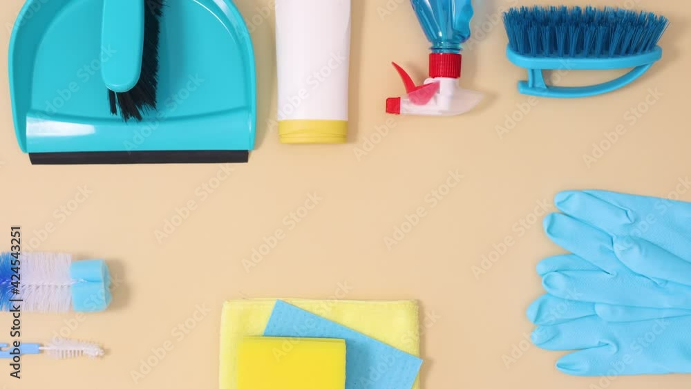 Cleaning tools household sanitary move on beige background with copy space. Stop motion flat lay Cleaning tools household sanitary move on beige background with copy space. Stop motion flat lay