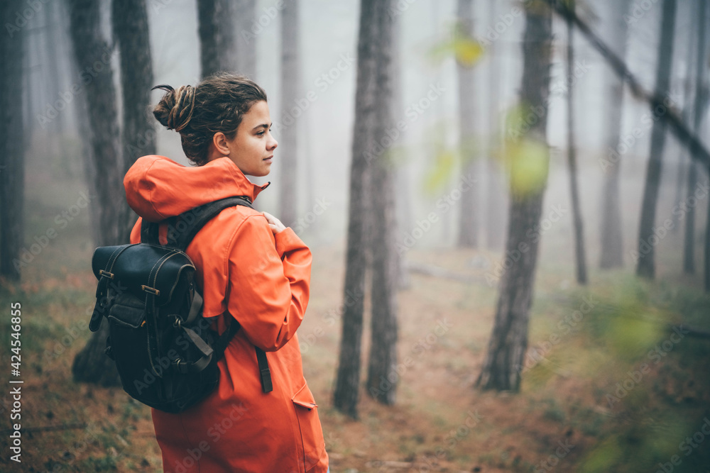 Woman walking in the foggy autumn forest. Woman walking in the foggy autumn forest.