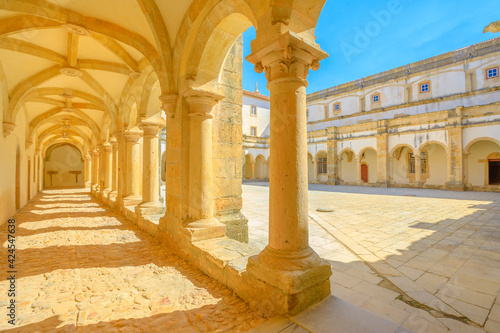 Tomar, Portugal - August 10, 2017: corridor inside small Claustro de Santa Barbara in Templar Castle of Tomar or Convent of Christ. Unesco Heritage and popular place. Sunny day, blue sky.