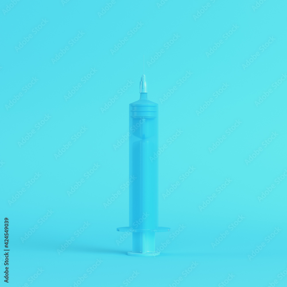 Syringe on bright blue background in pastel colors Syringe on bright blue background in pastel colors