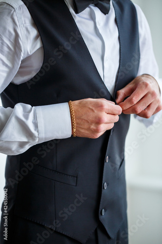 Young male businessman is dressing a stylish suit for an important meeting. Clothing for an adult man