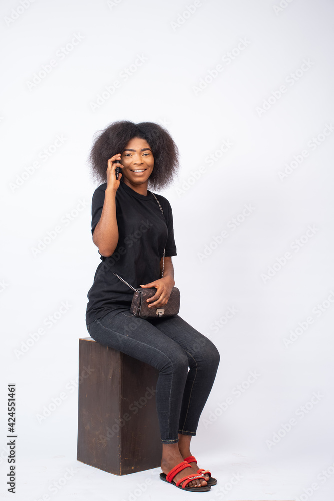 beautiful young black lady making a phone call on a white background beautiful young black lady making a phone call on a white background