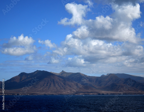 Calm sea, mountains and blue sky with clouds, coast of Jandia, Fuerteventura, Canary Islands