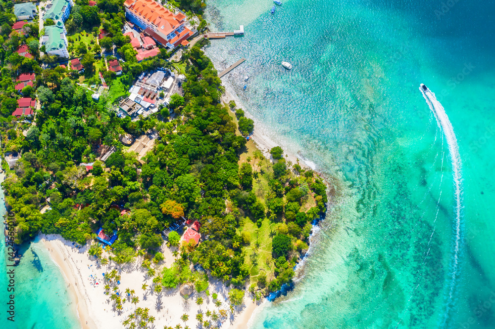 Aerial drone view of beautiful caribbean tropical island Cayo Levantado beach with palms and boat. Bacardi Island, Samana, Dominican Republic. Vacation background.