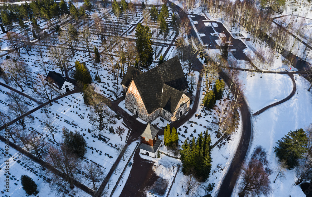 Aerial view of the Espoo Cathedral in the cemetery on winter sunny day, Finland.
