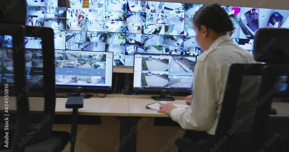 Security guards monitoring modern CCTV cameras in surveillance room Security guards monitoring modern CCTV cameras in surveillance room