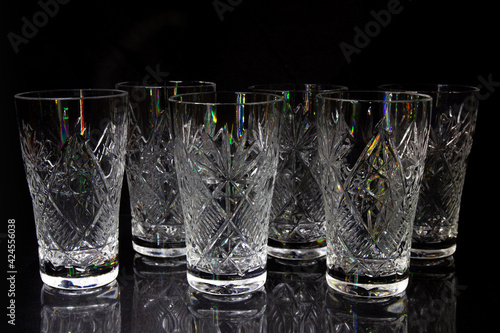 6 empty crystal bowls symmetrically on a black background 