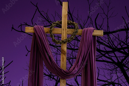 Foto wooden cross, crown of thorns and purple fabric