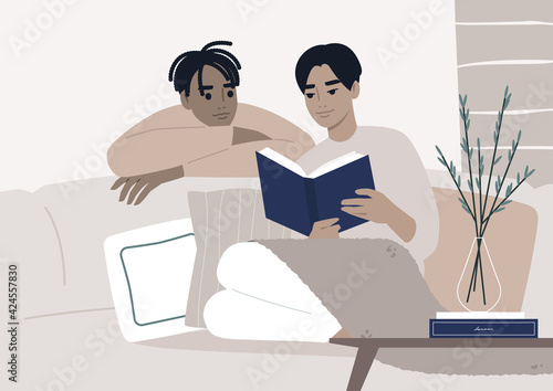 Weekend leisure activities, a gay couple reading a book together in the living room, cozy domestic life during the lockdown