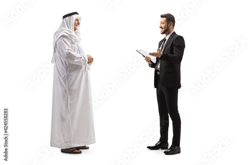 Obraz na plátně Full length profile shot of a young businessman talking to a mature arab man