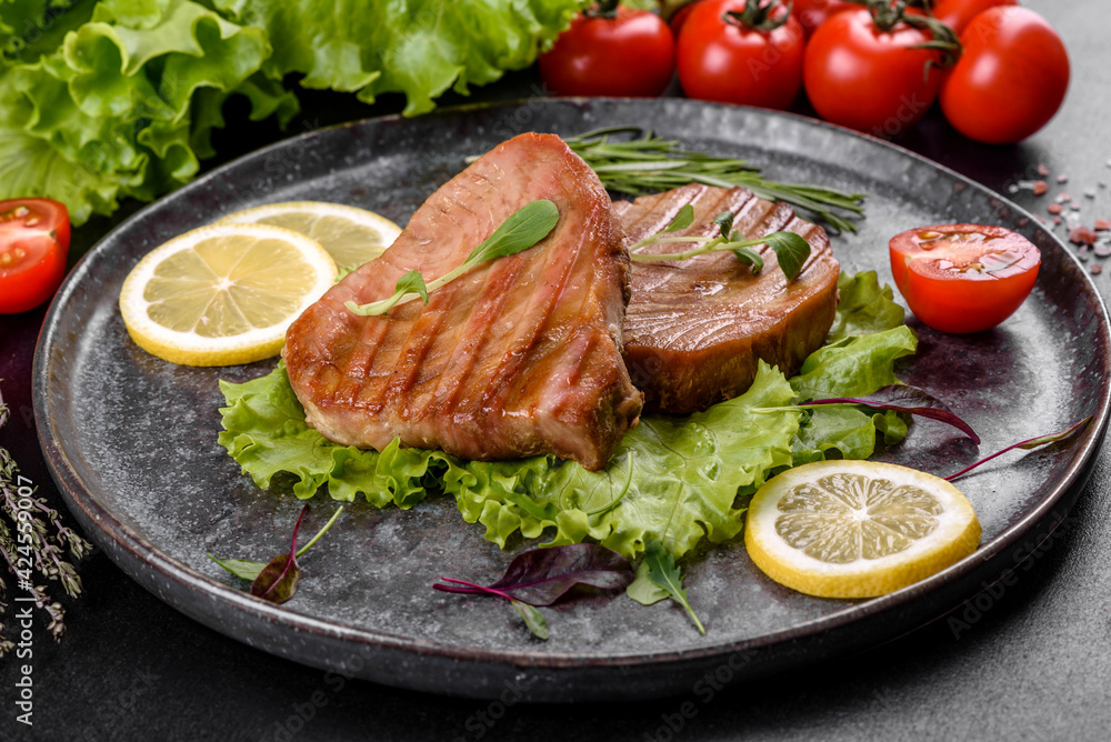 Delicious juicy tuna steak grilled with spices and herbs Delicious juicy tuna steak grilled with spices and herbs