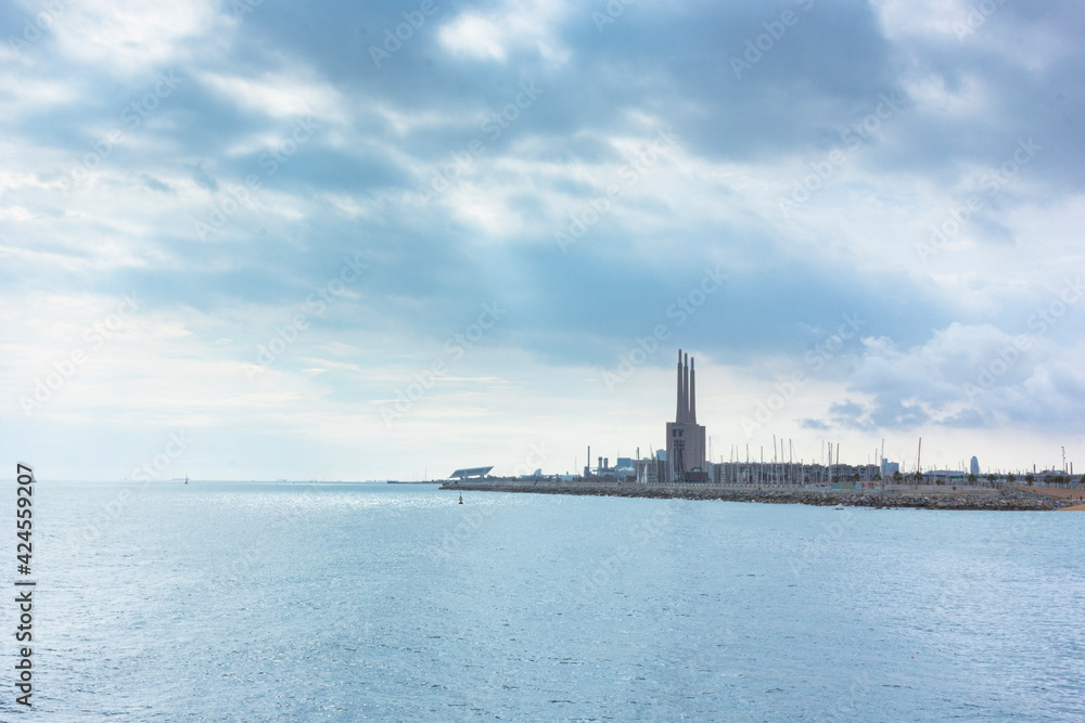 Seascape in the Mediterranean Sea with views of an old disused Thermal Power Plant for the production of electricity Seascape in the Mediterranean Sea with views of an old disused Thermal Power Plant for the production of electricity