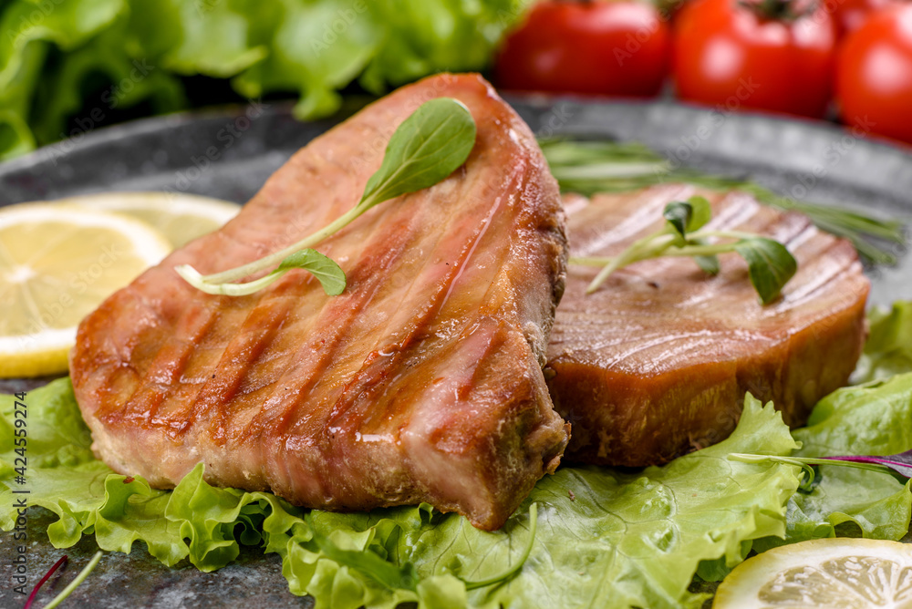 Delicious juicy tuna steak grilled with spices and herbs Delicious juicy tuna steak grilled with spices and herbs