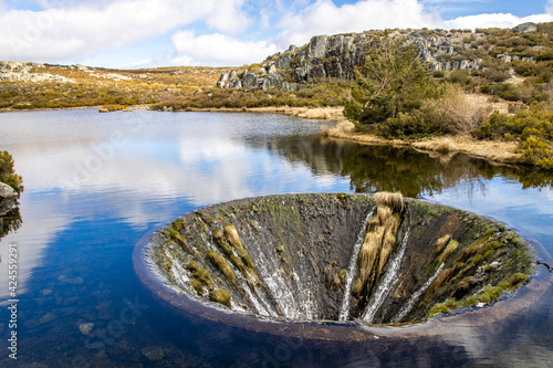 Covao Dos Conchos - A hole in the middle of the Lake in Serra da Estrela. Bell mouth spillway in Portugal © Lukas