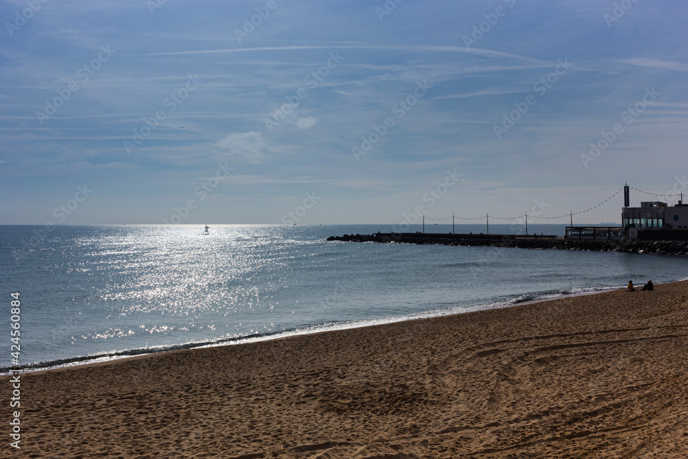 Barcelona beach in winter, with a calm sea.