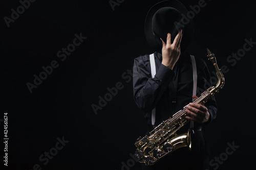 Artist with saxophone in studio photo