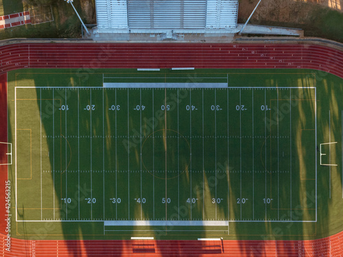 Aerial straight down shot of a high school track and football field in Texas at sunrise