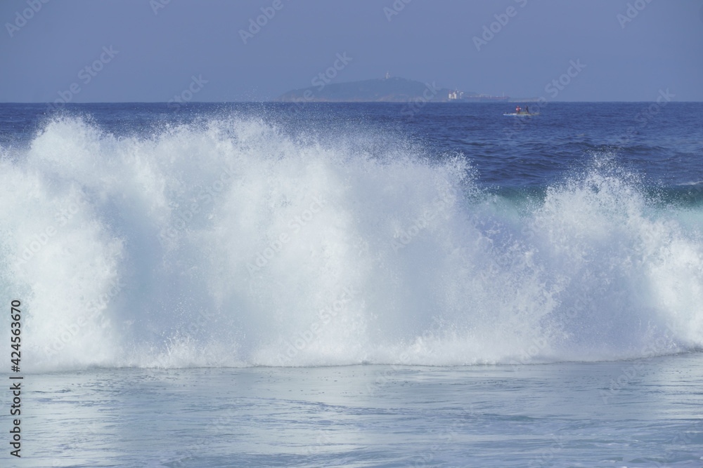 Waves crashing in the sea at Piratininga Beach, Niterói in Rio de Janeiro. Sunny day.
