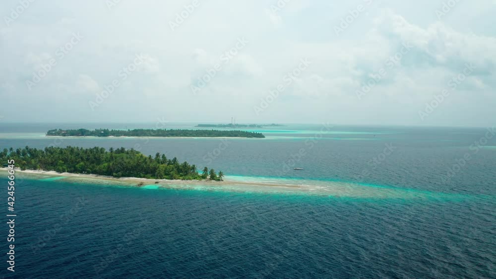 Aerial view of a tropical island in the Indian Ocean. Thinadhoo (Vaavu Atoll), Maldives Aerial view of a tropical island in the Indian Ocean. Thinadhoo (Vaavu Atoll), Maldives