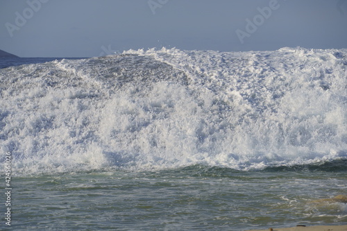 Waves crashing in the sea at Piratininga Beach, Niterói in Rio de Janeiro. Sunny day. photo