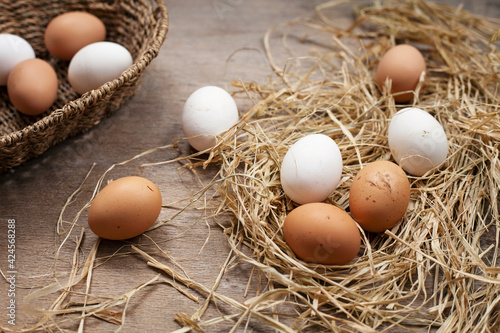 Basket in eggs on wooden background.