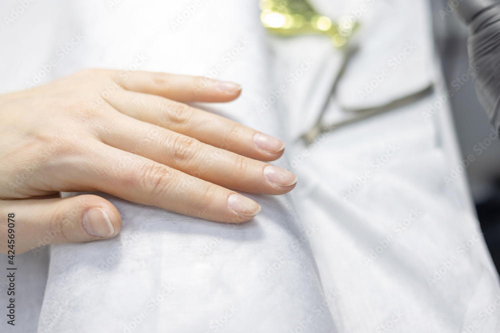 elegant female hands before procedure manicure in a beauty salon elegant female hands before procedure manicure in a beauty salon
