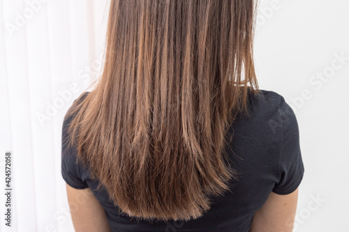 the result of hair coloring and styling in a beauty salon for a young woman