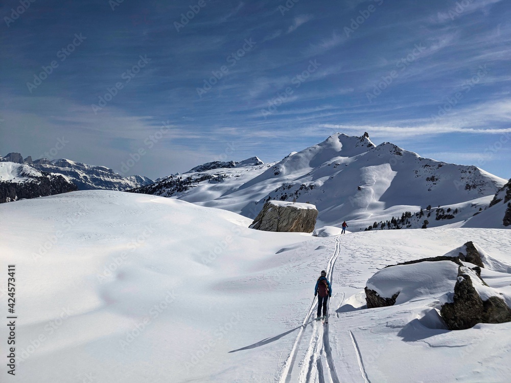 Freerider downhill mountain powder snow. Ski tour in the Swiss mountains. Young man enjoys life. Skimo. Skiing. Glarus