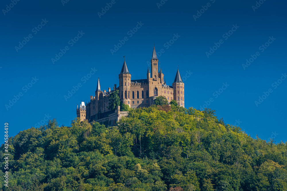 Aerial view of famous Hohenzollern Castle, ancestral seat of the imperial House of Hohenzollern and one of Europe's most visited castles, on the top of a green hill in Baden-Wurttemberg, Germany