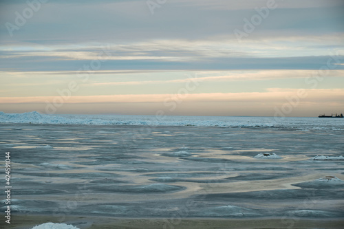 icy beach on the background of the sunset