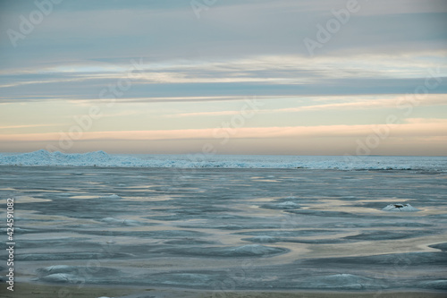icy beach on the background of the sunset