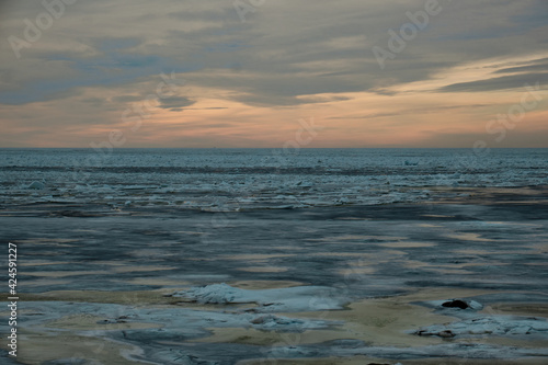 icy beach on the background of the sunset