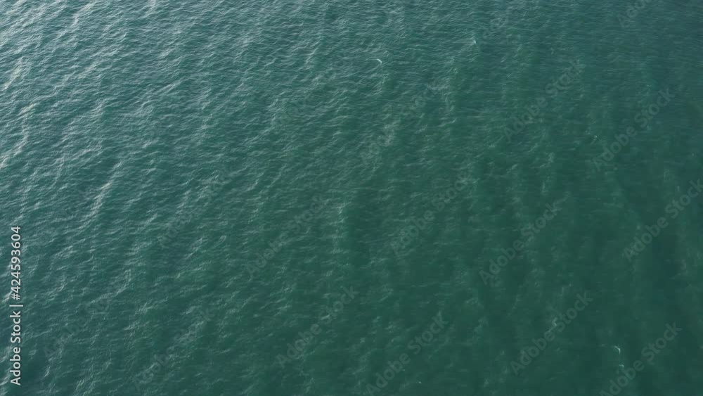 Aerial view drone slide forward. Small waves on sea. Aerial view drone slide forward. Small waves on sea.