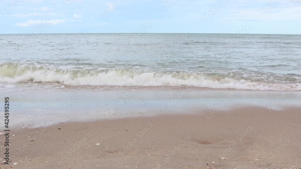 Wind blowing over sea waves on the beach in daytime. The waves hitting the empty sandy beach.
Wind blowing over sea waves on the beach in daytime. The waves hitting the empty sandy beach.
