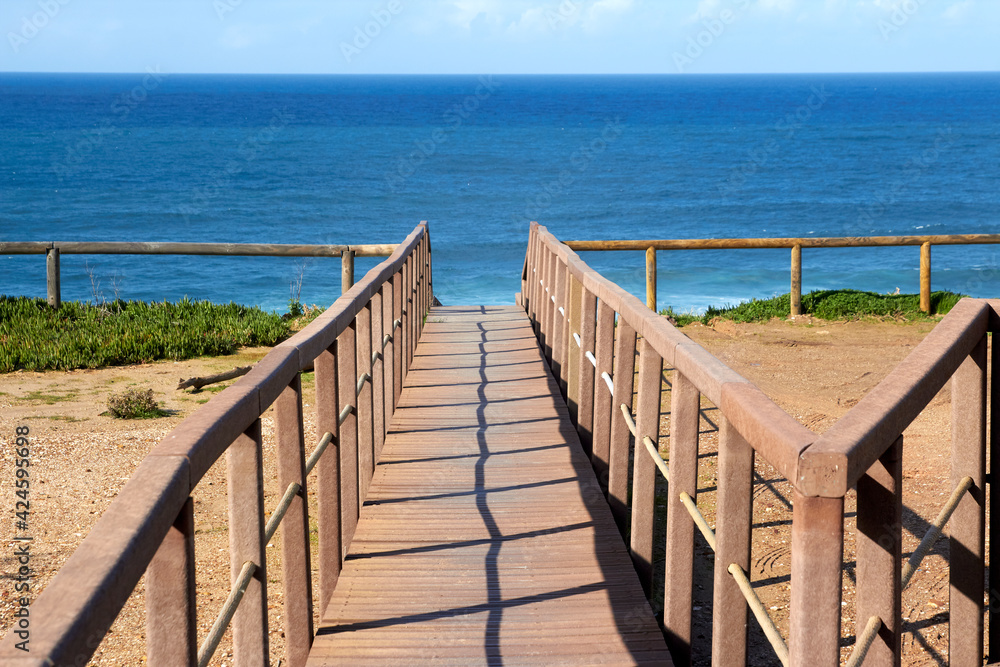 Wooden footbridge on the way to a beach in Algarve Portugal.