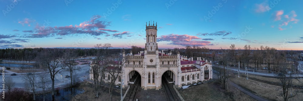 Panoramic aerial view of Novy Peterhof station at sunset. Railroad station. Station of the October railway. Pseudo-gothic style. Russia, Peterhof, 1.04.2021