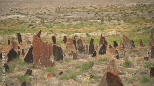 Tombstones and obelisks in the prehistoric cemetery.Anthropomorphic kurgan stone stelae statue menhirs steles ancient monument.Menhir orthostat lith old bronze age megalith Stele mass graveyard grave  photo