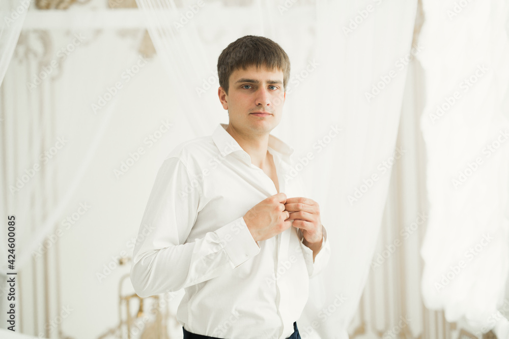 Beautiful man, groom posing and preparing for wedding Beautiful man, groom posing and preparing for wedding