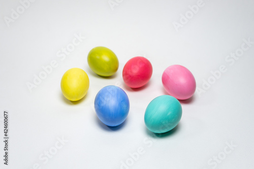 Six colorful eggs on white background. Selective focus. Creative Easter background