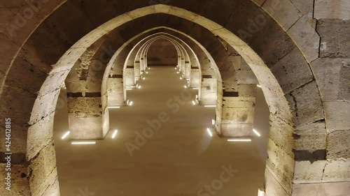 Interior of historical building with stone arches and domes.Cathedral minster church sultan Han caravanserai caravansary khan wikala funduq medieval architecture caravanserais niche courtyard detail. photo